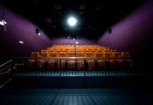 영화관람권·항공료 등에 붙는 18개 부담금 없앤다 orange and white chairs with lights turned on in a stadium